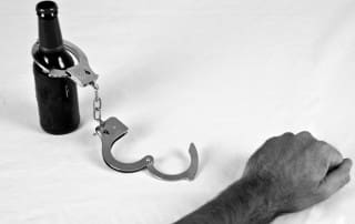 Addiction Is AThief - black and white handcuffs and beer