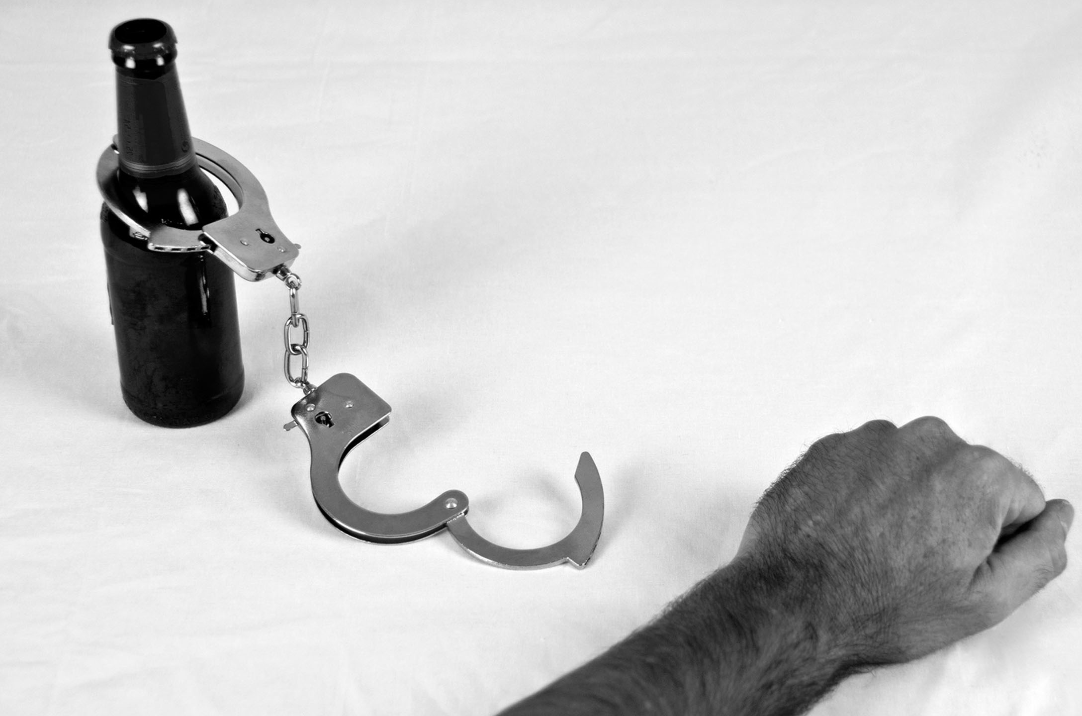 Addiction Is AThief - black and white handcuffs and beer