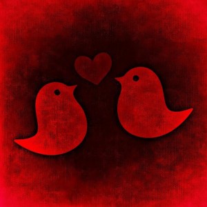 painting in all red colors of two little birds with a heart between them