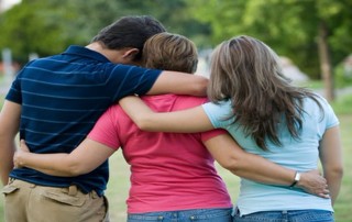 family with arms around each other