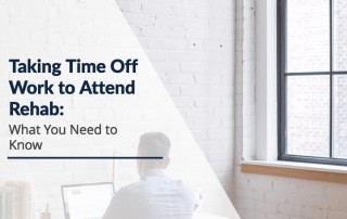 man sitting at desk at work - taking time off work to attend rehab