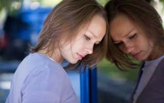 Portrait of sad woman outside office building background