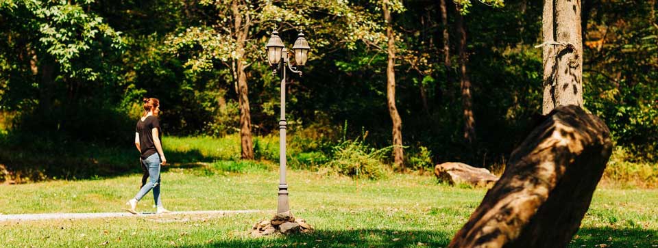 Woman walking on a path at St. Joesph Institute for Addiction - alcohol and drug rehab center in PA - Christian rehab