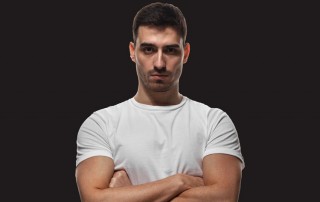 man with arms crossed - staring at camera