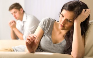 couple arguing, woman looking at wedding ring