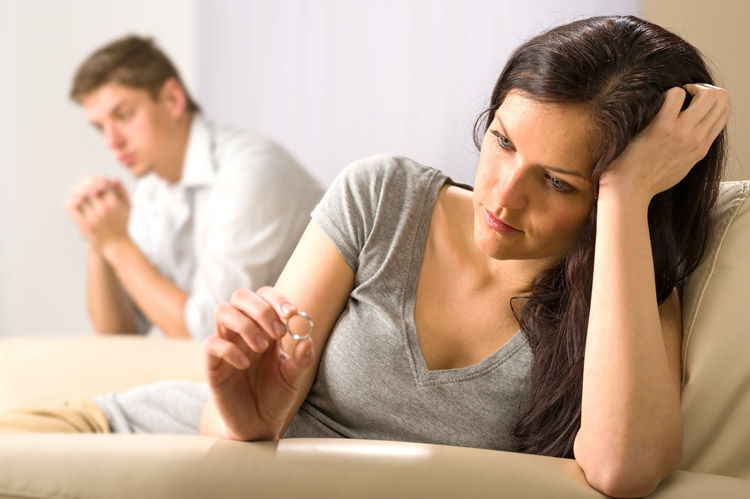 couple arguing, woman looking at wedding ring