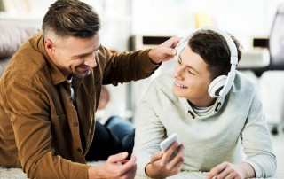 dad listening to music with son