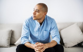 upset man sitting on couch