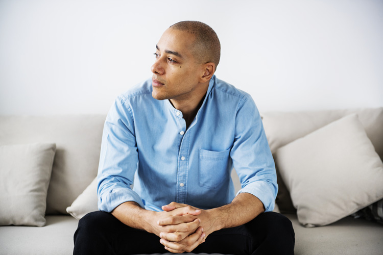 upset man sitting on couch