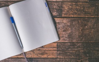 blank journal laying open on wooden table - journal