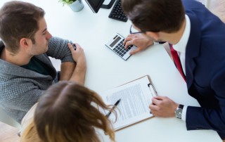 couple talking to banker or financial expert - paying