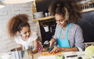 beautiful mother and daughter cooking in kitchen together - mother