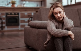 sad woman sitting on floor at home - your recovery