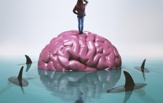 illustration - woman standing on brain in water surrounded by sharks - tolerance