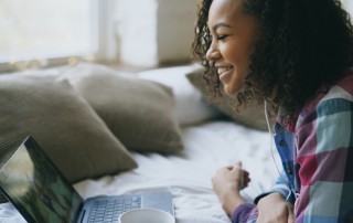 pretty African American woman using laptop at home for video call - staying connected - recovery