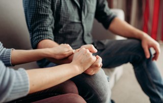 Bipolar Loved One Stay Sober, closeup of woman holding man's hand in support - bipolar