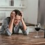 crying young woman drinking wine at home - loneliness and depression