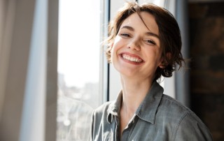beautiful young woman with dark brown short hair smiling at the camera - recovery journey