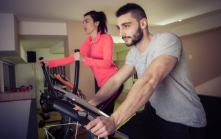 man and woman each on a cardio workout machine - exercise and mood