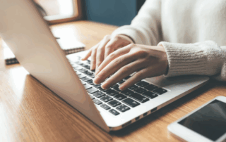 A person typing on a laptop.
