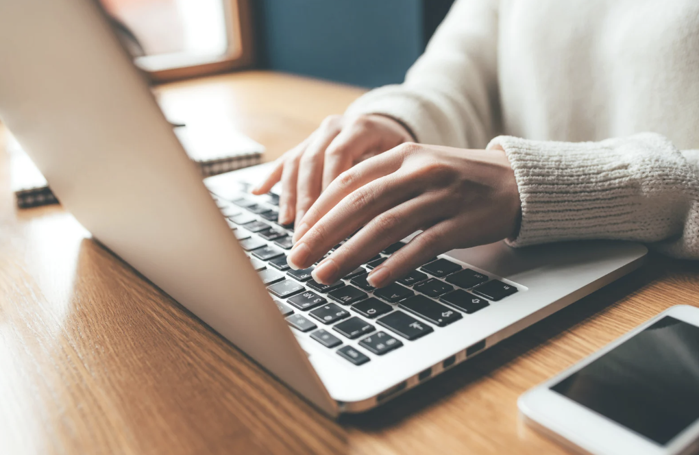 A person typing on a laptop.
